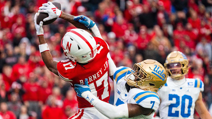 Nov 2, 2024; Lincoln, Nebraska, USA; Nebraska Cornhuskers wide receiver Jacory Barney Jr. (17) makes a catch against UCLA Bruins defensive back K.J. Wallace (7) during the third quarter at Memorial Stadium. Mandatory Credit: Dylan Widger-Imagn Images