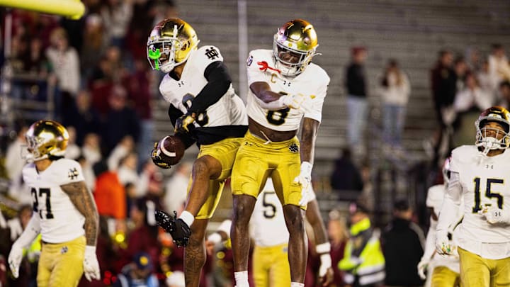 Nov 1, 2025; Chestnut Hill, Massachusetts, USA; Notre Dame safeties Tae Johnson (9) and Adon Shuler (8) leap and celebrate an interception in the fourth quarter against the Boston College Eagles at Alumni Stadium. Mandatory Credit: Edward Finan-Imagn Images