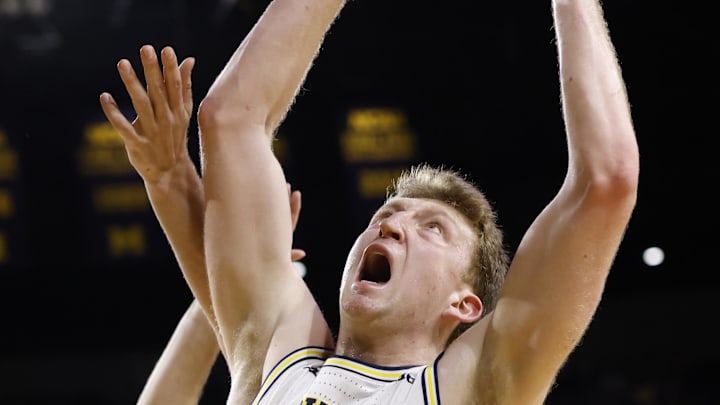 Jan 12, 2025; Ann Arbor, Michigan, USA; Michigan Wolverines center Danny Wolf (1) grabs the rebound in the second half against the Washington Huskies at Crisler Center. Mandatory Credit: Rick Osentoski-Imagn Images