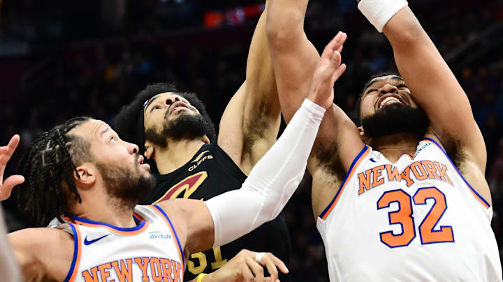Feb 21, 2025; Cleveland, Ohio, USA;  Cleveland Cavaliers center Jarrett Allen (31) goes for a rebound against New York Knicks guard Jalen Brunson (11) and center Karl-Anthony Towns (32) during the second half at Rocket Arena. Mandatory Credit: Ken Blaze-Imagn Images