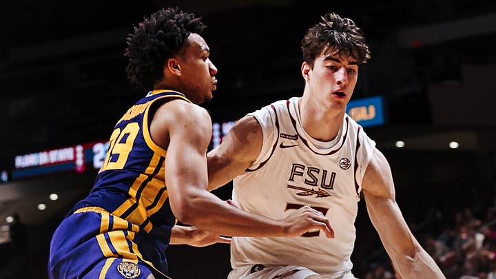 Florida State Seminoles forward Sebastian Rancik drives the ball against LSU Tigers guard Divie Ugochukwu Florida State Seminoles forward Sebastian Rancik drives the ball against LSU Tigers guard Divie Ugochukwu