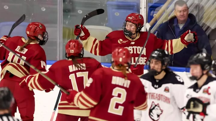 Ava Thomas celebrates with teammates after overtime goal against Northeastern.