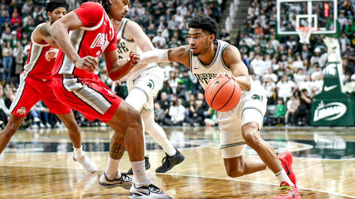 Michigan State's Jaden Akins, right, moves the ball as Ohio State's Devin Royal defends during the