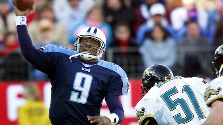Tennessee Titans quarterback Steve McNair (9) passes over Jacksonville Jaguars defender Kevin Hardy (51) at Adelphia Coliseum Dec. 26, 1999. McNair threw for 5 touchdowns on the day before taking the bench in the 4th quarter of 41-14 victory.

991226 A
