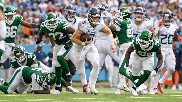 Sep 15, 2024; Nashville, Tennessee, USA;  Tennessee Titans quarterback Will Levis (8) breaks the tackle of New York Jets defensive tackle Quinnen Williams (95) during the second half at Nissan Stadium.