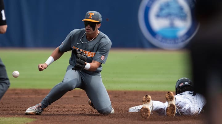 Vanderbilt Commodores' Rustan Rigdon (19) dives safely into second base before Tennessee Volunteer's Dean Curley (1) can get the ball as Vanderbilt Commodores take on Tennessee Volunteer during the SEC baseball tournament at Hoover Met in Birmingham, Ala., on Saturday, May 24, 2025.