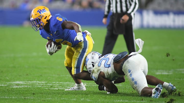 Pittsburgh Panthers Rodney Hammond Jr. (6) gets tripped up by North Carolina Tar Heels Power Echols (23) during the first half at Acrisure Stadium in Pittsburgh, PA on September 23, 2023.