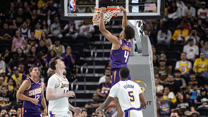 Oct 6, 2024; Palm Desert, California, USA;  Phoenix Suns center Oso Ighodaro (4) dunks the ball over Los Angeles Lakers forward Cam Reddish (5) during the second half at Acrisure Arena. Mandatory Credit: David Frerker-Imagn Images