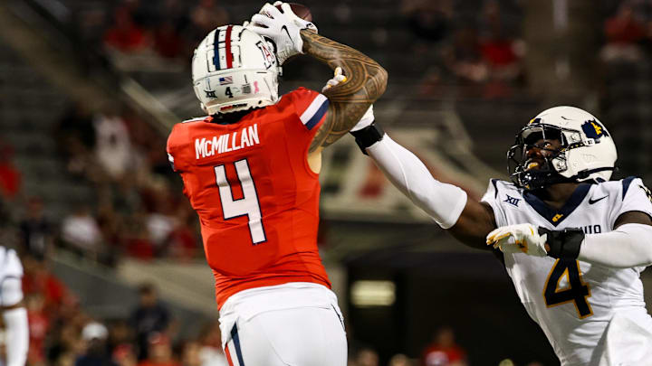 Oct 26, 2024; Tucson, Arizona, USA; Arizona Wildcats wide receiver Tetairoa McMillan (4) catches a long pass while West Virginia Mountaineers linebacker Trey Lathan (4) fails to defend against him during the fourth quarter at Arizona Stadium. Mandatory Credit: Aryanna Frank-Imagn Images Oct 26, 2024; Tucson, Arizona, USA; Arizona Wildcats wide receiver Tetairoa McMillan (4) catches a long pass while West Virginia Mountaineers linebacker Trey Lathan (4) fails to defend against him during the fourth quarter at Arizona Stadium. Mandatory Credit: Aryanna Frank-Imagn Images