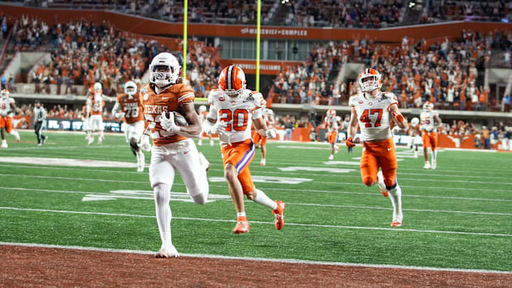 Texas Longhorns running back Jaydon Blue (23) runs into the endzone for a touchdown against Clemson Tigers cornerback Avieon Terrell (20) and Clemson Tigers linebacker Sammy Brown (47) in the second half of an NCAA College Football Playoffs first round game at Darrell K Royal Texas Memorial Stadium, Austin, Texas, Saturday, Dec. 21, 2024. Texas Longhorns running back Jaydon Blue (23) runs into the endzone for a touchdown against Clemson Tigers cornerback Avieon Terrell (20) and Clemson Tigers linebacker Sammy Brown (47) in the second half of an NCAA College Football Playoffs first round game at Darrell K Royal Texas Memorial Stadium, Austin, Texas, Saturday, Dec. 21, 2024.