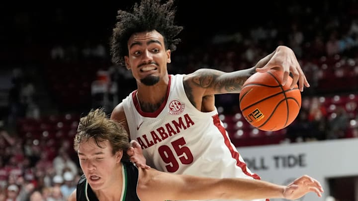Nov 3, 2025; Tuscaloosa, Alabama, USA; Alabama guard Houston Mallette (95) is fouled by North Dakota guard Greyson Uelmen (3) during the season-opening game at Coleman Coliseum.