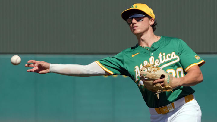 Mar 2, 2025; Mesa, Arizona, USA; Oakland Athletics second base Zack Gelof (20) makes the play for an out against the Los Angeles Dodgers  in the second inning at Hohokam Stadium. Mandatory Credit: Rick Scuteri-Imagn Images