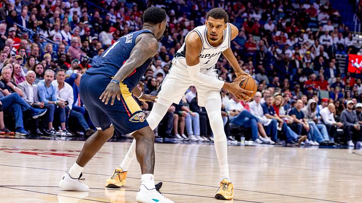 Oct 24, 2025; New Orleans, Louisiana, USA;  San Antonio Spurs forward/center Victor Wembanyama (1) dribbles against New Orleans Pelicans forward Zion Williamson (1) during the first half at Smoothie King Center. Mandatory Credit: Stephen Lew-Imagn Images