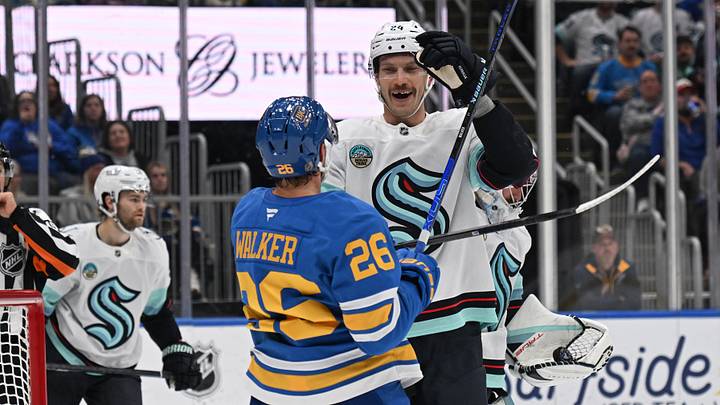 Nov 8, 2025; St. Louis, Missouri, USA; St. Louis Blues left wing Nathan Walker (26) gets physical with Seattle Kraken defenseman Jamie Oleksiak (24) in the second period at Enterprise Center. Mandatory Credit: Joe Puetz-Imagn Images