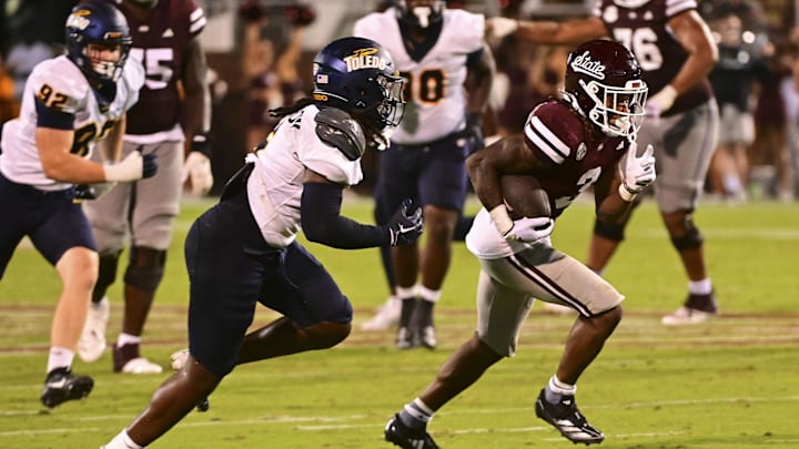 Sep 14, 2024; Starkville, Mississippi, USA; Mississippi State Bulldogs wide receiver Kevin Coleman Jr. (3) runs the ball while defended by Toledo Rockets linebacker Jackson Barrow (5) during the fourth quarter at Davis Wade Stadium at Scott Field. Mandatory Credit: Matt Bush-Imagn Images