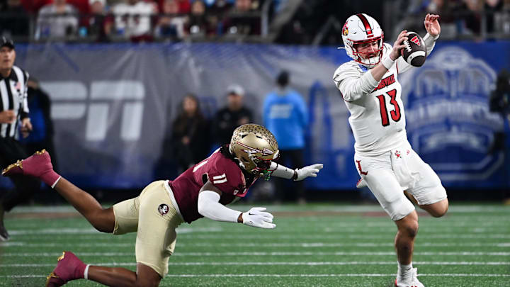 Dec 2, 2023; Charlotte, NC, USA; Louisville Cardinals quarterback Jack Plummer (13) evades a tackle by DUPLICATE***Florida State Seminoles defensive lineman Patrick Payton (11) in the first quarter at Bank of America Stadium. Mandatory Credit: Bob Donnan-Imagn Images