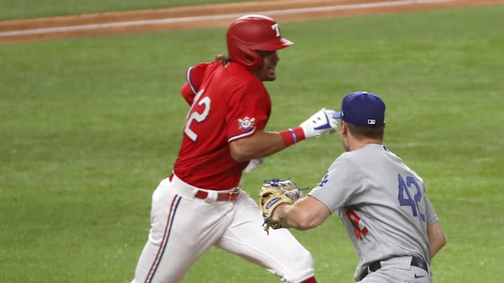 Dodgers starting pitcher Ross Stripling cannot tag out Texas Rangers first baseman Ronald Guzman during the fifth inning at Globe Life Field on Aug. 29, 2020.