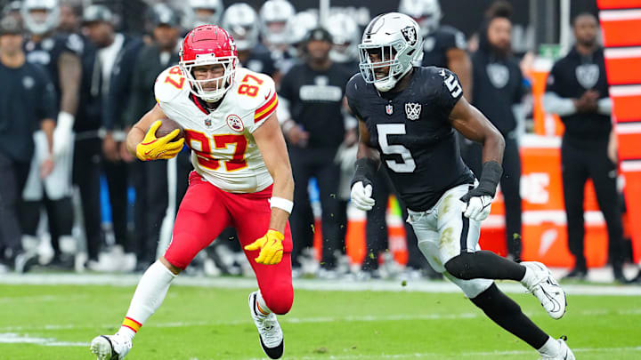 Oct 27, 2024; Paradise, Nevada, USA; Kansas City Chiefs tight end Travis Kelce (87) looks to evade the tackle of Las Vegas Raiders linebacker Divine Deablo (5) during the first quarter at Allegiant Stadium. Mandatory Credit: Stephen R. Sylvanie-Imagn Images Oct 27, 2024; Paradise, Nevada, USA; Kansas City Chiefs tight end Travis Kelce (87) looks to evade the tackle of Las Vegas Raiders linebacker Divine Deablo (5) during the first quarter at Allegiant Stadium. Mandatory Credit: Stephen R. Sylvanie-Imagn Images