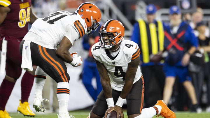 Aug 11, 2023; Cleveland, Ohio, USA; Cleveland Browns quarterback Deshaun Watson (4) celebrates his first down run with offensive tackle Jedrick Wills Jr. (71) against the Washington Commanders during the first quarter at Cleveland Browns Stadium. Mandatory Credit: Scott Galvin-USA TODAY Sports
