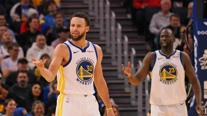 Golden State Warriors guard Stephen Curry (30) and forward Draymond Green (23) question the referee after a play against the Portland Trail Blazers during the fourth quarter at Chase Center.
