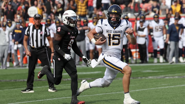 Nov 1, 2025; Houston, Texas, USA; West Virginia Mountaineers quarterback Scotty Fox Jr. (15) rushes for a touchdown against Houston Cougars linebacker Corey Platt Jr. (9)  in the second half at TDECU Stadium. Mandatory Credit: Thomas Shea-Imagn Images
