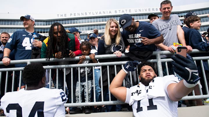 Penn State Nittany Lions offensive lineman Vega Ioane (right) takes a selfie following the Blue-White Game at Beaver Stadium.