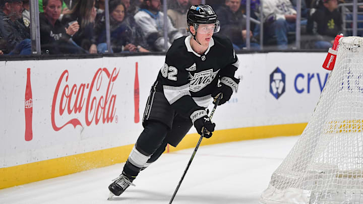 Feb 7, 2025; Los Angeles, California, USA; Los Angeles Kings defenseman Brandt Clarke (92) moves the puck against the Dallas Stars durng the first period at Crypto.com Arena. Mandatory Credit: Gary A. Vasquez-Imagn Images
