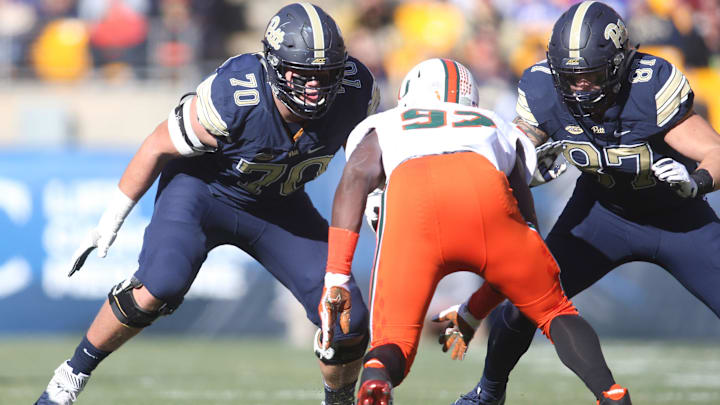 Nov 24, 2017; Pittsburgh, PA, USA;  Pittsburgh Panthers offensive lineman Brian O'Neill (70) and tight end Chris Clark (87) block Miami Hurricanes defensive lineman Jonathan Garvin (97) at the line of scrimmage during the first quarter at Heinz Field. PITT won 24-14. Mandatory Credit: Charles LeClaire-Imagn Images