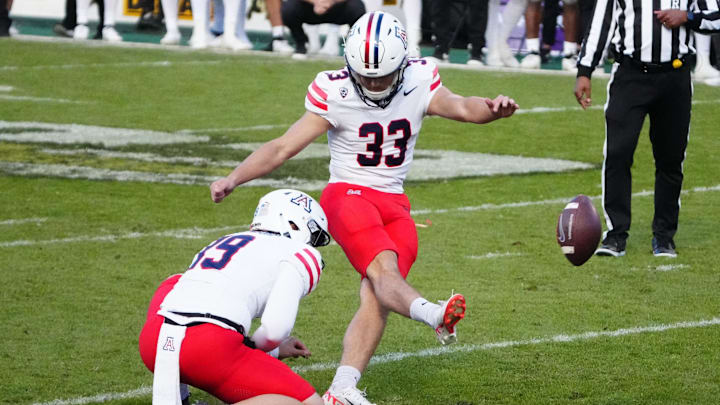 Nov 11, 2023; Boulder, Colorado, USA; Arizona Wildcats place kicker Tyler Loop (33) kicks the winning field goal in the fourth quarter against the Colorado Buffaloes at Folsom Field. Mandatory Credit: Ron Chenoy-Imagn Images