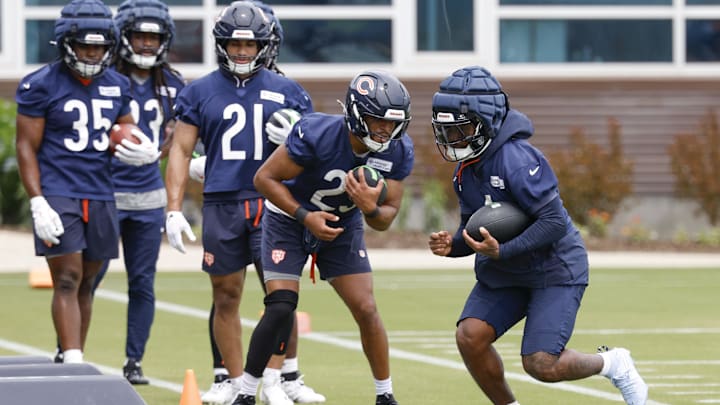 D'Andre Swift (right) and Roschon Johnson run through running back drills under the watchful eye of coach Eric Bieniemy. D'Andre Swift (right) and Roschon Johnson run through running back drills under the watchful eye of coach Eric Bieniemy.