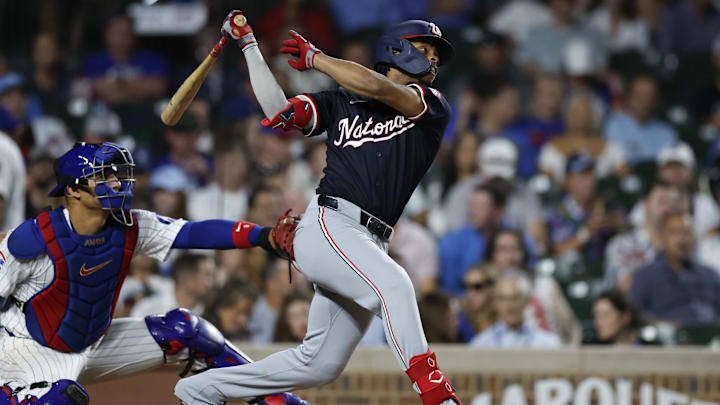 Sep 19, 2024; Chicago, Illinois, USA; Washington Nationals third baseman Jose Tena (8) hits an RBI single against the Chicago Cubs during the third inning at Wrigley Field. 