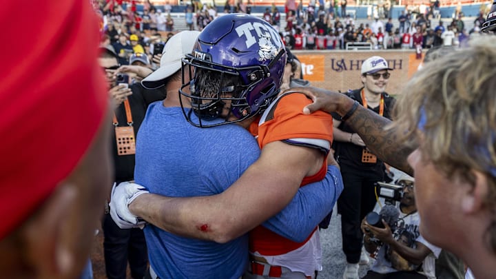 Feb 1, 2025; Mobile, AL, USA; American team wide receiver Jack Bech of TCU (7) is embraced by his uncle Brett Bech after catching the game-winning touchdown on the game's final play at Hancock Whitney Stadium. Jack Bech recently lost his brother in the New Year’s Day mass killing in New Orleans. 