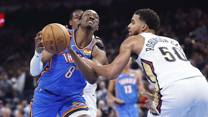 Nov 13, 2024; Oklahoma City, Oklahoma, USA; Oklahoma City Thunder forward Jalen Williams (8) is fouled by New Orleans Pelicans forward Jeremiah Robinson-Earl (50) on a drive to the basket during the second quarter at Paycom Center. Mandatory Credit: Alonzo Adams-Imagn Images
