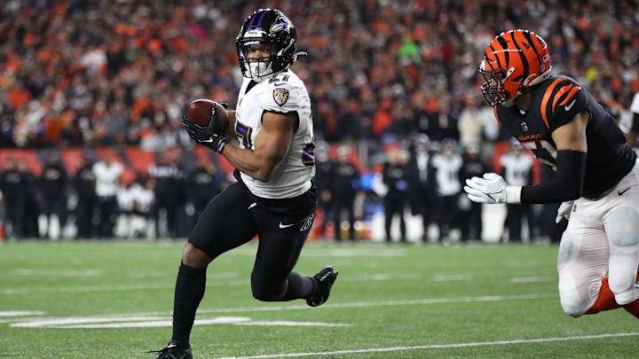 Jan 15, 2023; Cincinnati, Ohio, USA; Baltimore Ravens running back J.K. Dobbins (27) runs the ball while defended by Cincinnati Bengals linebacker Markus Bailey (51) during the first half in a wild card game at Paycor Stadium. Mandatory Credit: Katie Stratman-Imagn Images
