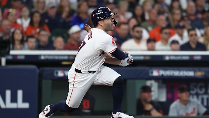 Oct 1, 2024; Houston, Texas, USA; Houston Astros second base Jose Altuve (27) hits a single in the third inning against the Detroit Tigers in game one of the Wild Card round for the 2024 MLB Playoffs at Minute Maid Park. 