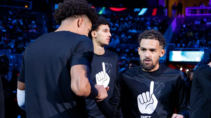 Jalen Johnson #1, Zaccharie Risacher #10, and Trae Young #1 of the Atlanta Hawks are introduced before facing the Dallas Mavericks.