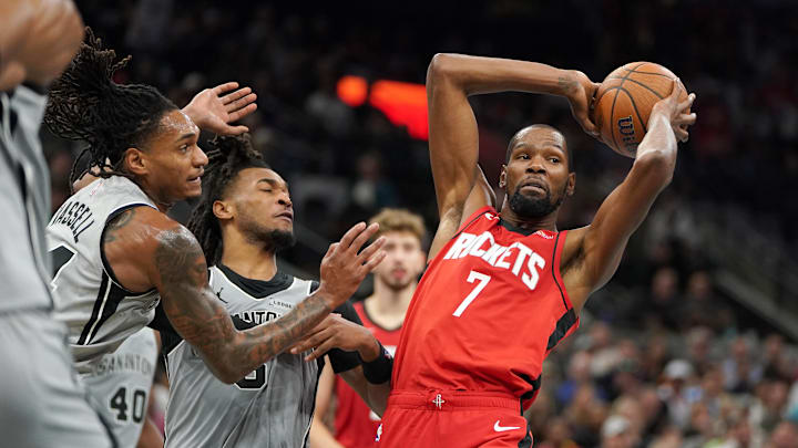 Nov 7, 2025; San Antonio, Texas, USA;  Houston Rockets forward Kevin Durant (7) passes against San Antonio Spurs guard Stephon Castle (5) and guard Devin Vassell (24) during the second quarter at Frost Bank Center. Mandatory Credit: Dustin Safranek-Imagn Images