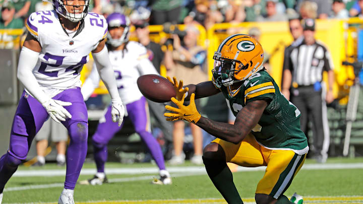 Former UVA wide receiver Dontayvion Wicks caught two touchdown passes in the fourth quarter for the Green Bay Packers against the Minnesota Vikings on Sunday at Lambeau Field.