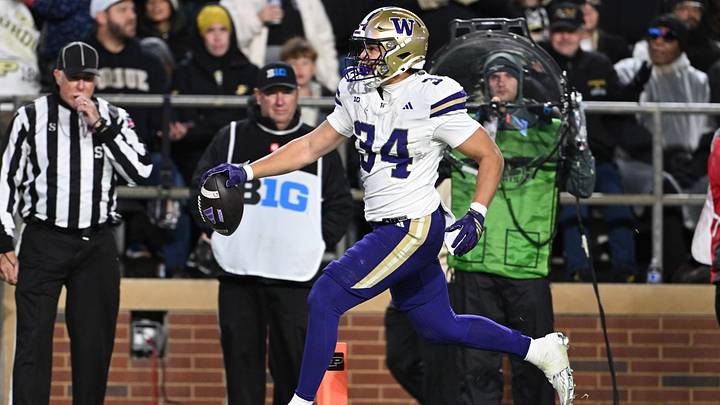 Huskies running back Brian Bonner (34) scores on s 25-yard pass from Elijah Brown at Purdue. Huskies running back Brian Bonner (34) scores on s 25-yard pass from Elijah Brown at Purdue.