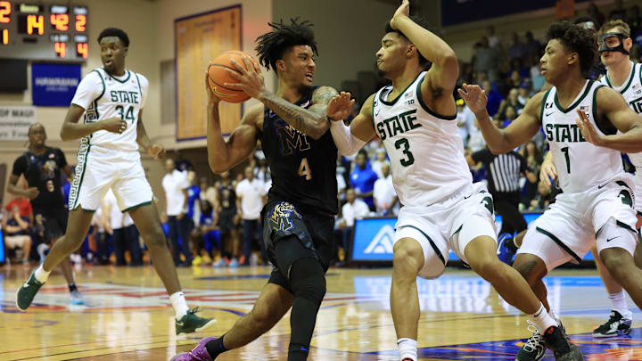 Nov 26, 2024; Lahaina, Hawaii, USA;  Memphis Tigers guard PJ Haggerty (4) drives against Michigan State Spartans guard Jaden Akins (3) during the first half at Lahaina Civic Center. Mandatory Credit: Marco Garcia-Imagn Images
