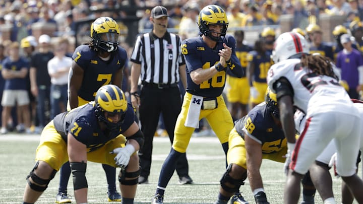 Sep 14, 2024; Ann Arbor, Michigan, USA; Michigan Wolverines quarterback Davis Warren (16) prepares to run a play against the Arkansas State Red Wolves during the first half at Michigan Stadium. Mandatory Credit: Rick Osentoski-Imagn Images Sep 14, 2024; Ann Arbor, Michigan, USA; Michigan Wolverines quarterback Davis Warren (16) prepares to run a play against the Arkansas State Red Wolves during the first half at Michigan Stadium. Mandatory Credit: Rick Osentoski-Imagn Images