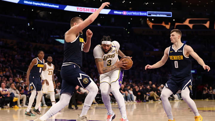 Nov 23, 2024; Los Angeles, California, USA; Los Angeles Lakers forward Anthony Davis (3) drives to the basket between Denver Nuggets center Nikola Jokic (15) and guard Christian Braun (0) during the third quarter at Crypto.com Arena. Mandatory Credit: Kiyoshi Mio-Imagn Images Nov 23, 2024; Los Angeles, California, USA; Los Angeles Lakers forward Anthony Davis (3) drives to the basket between Denver Nuggets center Nikola Jokic (15) and guard Christian Braun (0) during the third quarter at Crypto.com Arena. Mandatory Credit: Kiyoshi Mio-Imagn Images