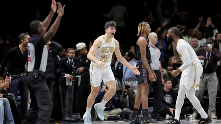 Jan 23, 2026; Brooklyn, New York, USA; Boston Celtics guard Hugo Gonzalez (28) celebrates his three point shot against Brooklyn Nets forward Noah Clowney (21) with Celtics guard Jaylen Brown (7) during the first overtime at Barclays Center. Mandatory Credit: Brad Penner-Imagn Images