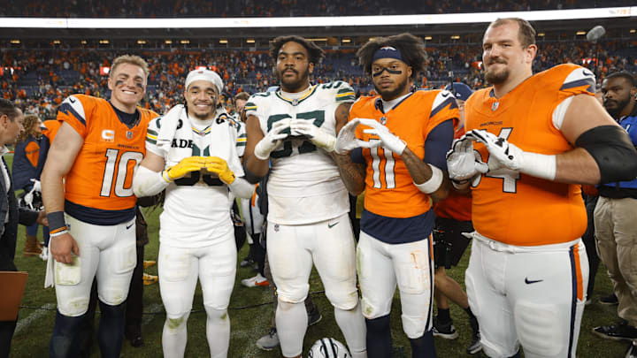 Dec 14, 2025; Denver, Colorado, USA; Denver Broncos quarterback Bo Nix (10), Green Bay Packers safety Evan Williams (33), Green Bay Packers defensive tackle Jordon Riley (97), Denver Broncos wide receiver Troy Franklin (11) and Denver Broncos center Alex Forsyth (54) pose for a photo following a game at Empower Field at Mile High. Mandatory Credit: Isaiah J. Downing-Imagn Images