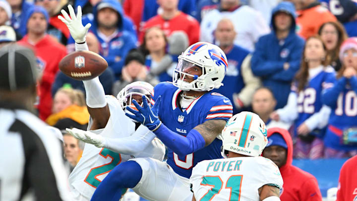 Nov 3, 2024; Orchard Park, New York, USA; Buffalo Bills wide receiver Keon Coleman (0) tries to make a catch as Miami Dolphins safety Jordan Poyer (21) and cornerback Cam Smith (24) defend in the fourth quarter at Highmark Stadium.