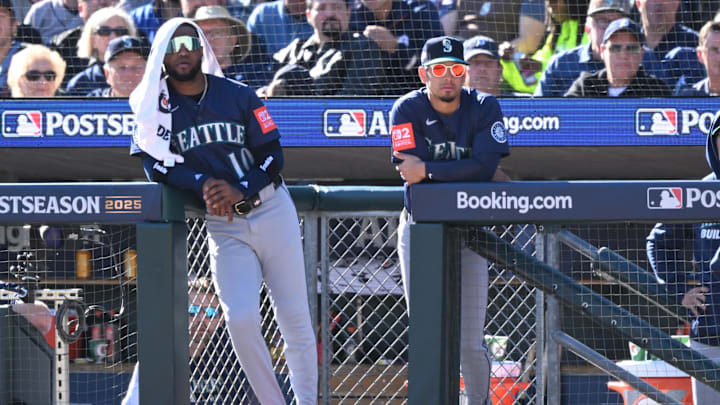 Oct 8, 2025; Detroit, Michigan, USA; Seattle Mariners right fielder Victor Robles (10) and second baseman Leo Rivas (76) look on from the dugout in the third inning during game four of the ALDS round for the 2025 MLB playoffs against the Detroit Tigers at Comerica Park. Mandatory Credit: Lon Horwedel-Imagn Images