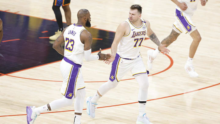 Apr 6, 2025; Oklahoma City, Oklahoma, USA; Los Angeles Lakers guard Luka Doncic (77) and forward LeBron James (23) high five after scoring against the Oklahoma City Thunder during the first quarter at Paycom Center. Mandatory Credit: Alonzo Adams-Imagn Images