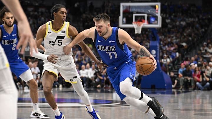 Oct 28, 2024; Dallas, Texas, USA; Utah Jazz forward Cody Williams (5) and Dallas Mavericks guard Luka Doncic (77) in action during the game between the Dallas Mavericks and the Utah Jazz at the American Airlines Center. Mandatory Credit: Jerome Miron-Imagn Images