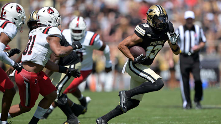 Aug 30, 2025; West Lafayette, Indiana, USA; Purdue Boilermakers wide receiver EJ Horton Jr. (13) runs the ball past Ball State Cardinals linebacker DeJuan Echoles Jr. (31) during the second half at Ross-Ade Stadium. Mandatory Credit: Marc Lebryk-Imagn Images