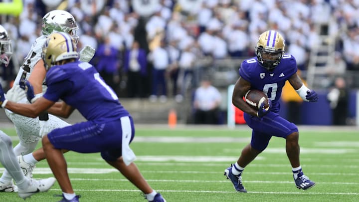 Oct 14, 2023; Seattle, Washington, USA; Washington Huskies wide receiver Giles Jackson (0) carries the ball against the Oregon Ducks during the game at Alaska Airlines Field at Husky Stadium. Mandatory Credit: Steven Bisig-Imagn Images